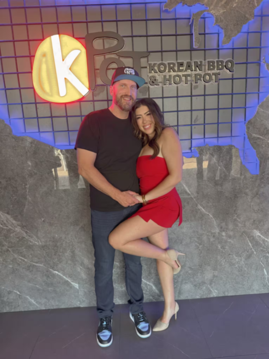 Travis and Chrissy posing together at KPOT Korean BBQ and Hot Pot.